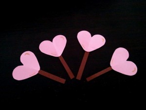 Attach the sticks to the back of the hearts.